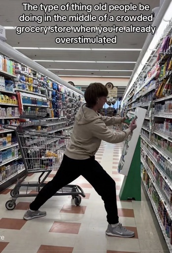 Photo of a person blocking a store aisle with their body and their shopping cart with the caption “The type of thing old people be doing in the middle of a crowded grocery store when you're already overstimulated”